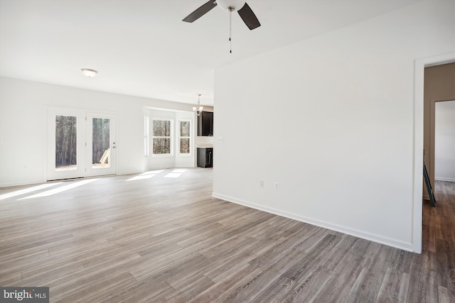 interior space with wood-type flooring and ceiling fan