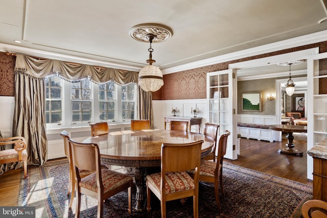 dining room with ornamental molding and dark hardwood / wood-style flooring