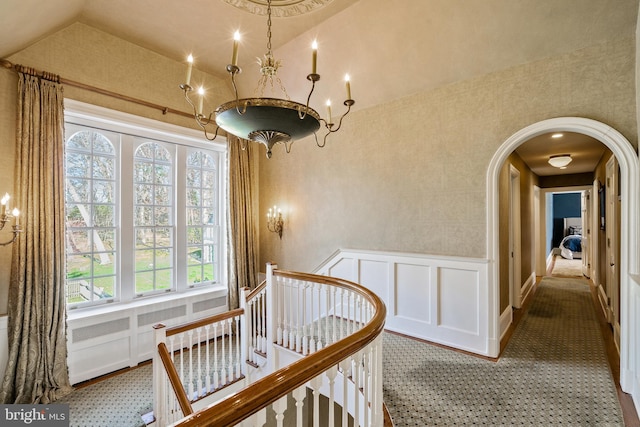 corridor with lofted ceiling and carpet flooring