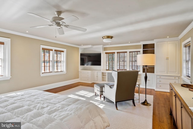 bedroom with hardwood / wood-style floors, multiple windows, crown molding, and ceiling fan