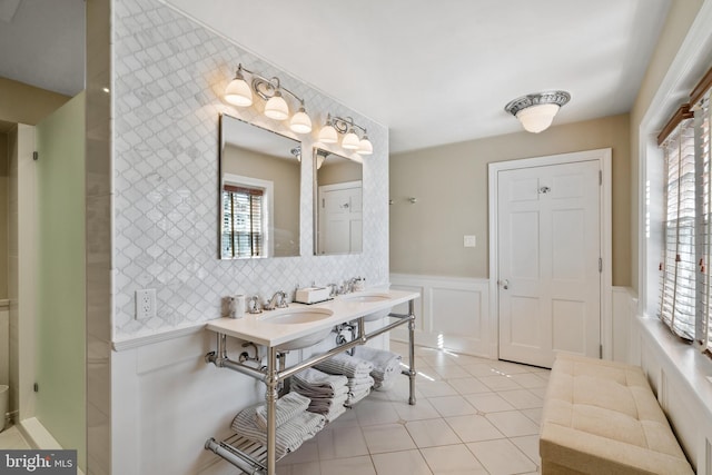 bathroom with backsplash, double vanity, and tile floors