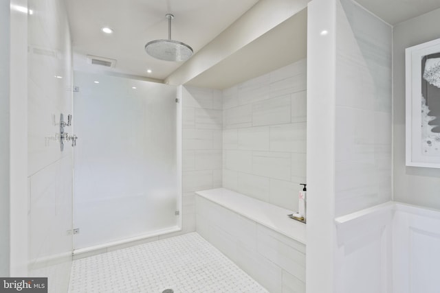 bathroom with tile floors and a tile shower