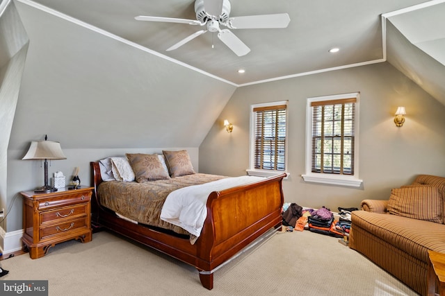 carpeted bedroom with ornamental molding, vaulted ceiling, and ceiling fan