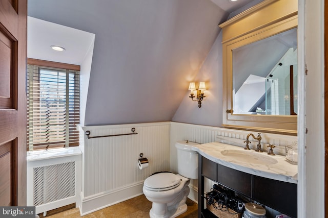 bathroom with tile flooring, lofted ceiling, toilet, radiator, and vanity