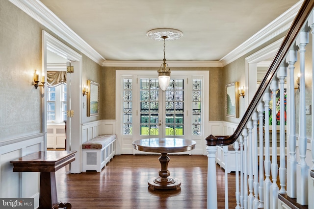 foyer entrance featuring ornamental molding and dark hardwood / wood-style flooring