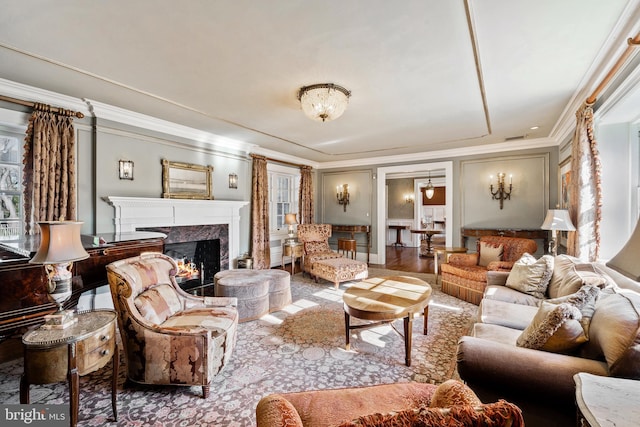 living room with wood-type flooring, a fireplace, and crown molding