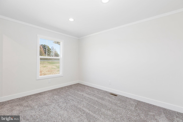 carpeted empty room featuring ornamental molding