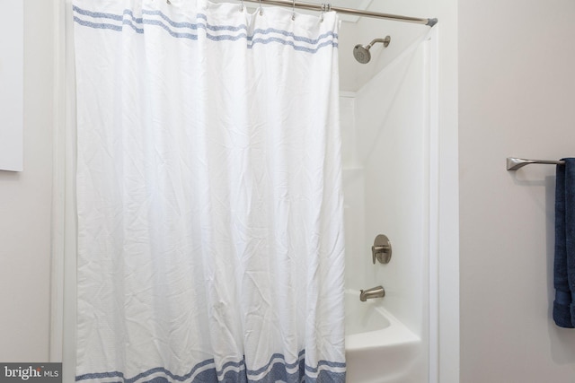 bathroom with shower / bath combination with curtain