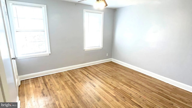 unfurnished room with a healthy amount of sunlight and light hardwood / wood-style floors