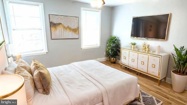 bedroom featuring light wood-type flooring and multiple windows