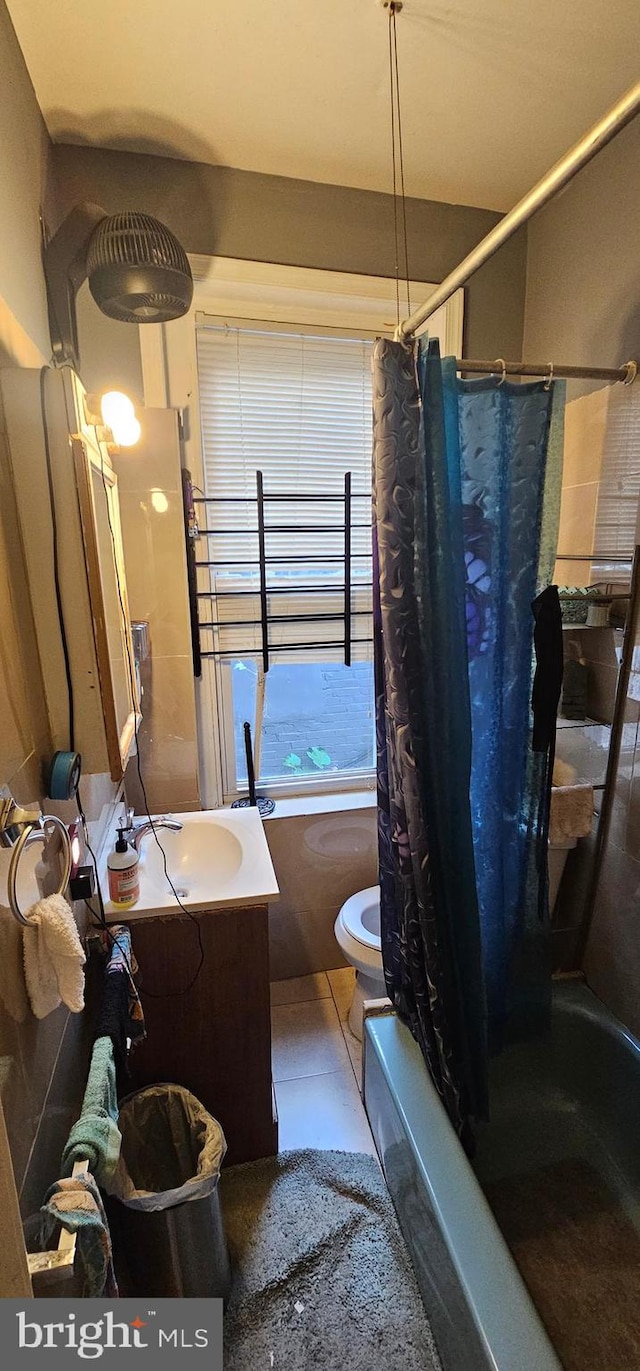 full bathroom with tile patterned flooring, shower / bath combo, vanity, and toilet