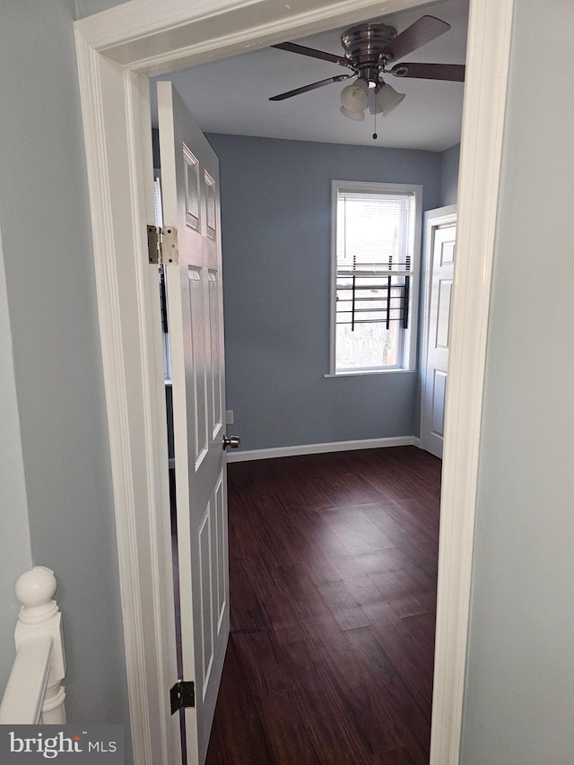 spare room with ceiling fan and dark hardwood / wood-style floors