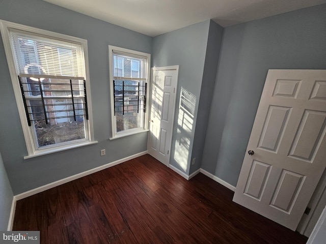 empty room featuring dark hardwood / wood-style flooring