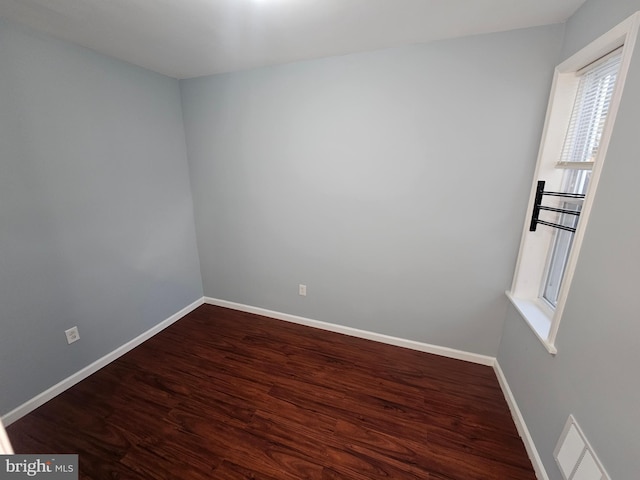 spare room with wood-type flooring