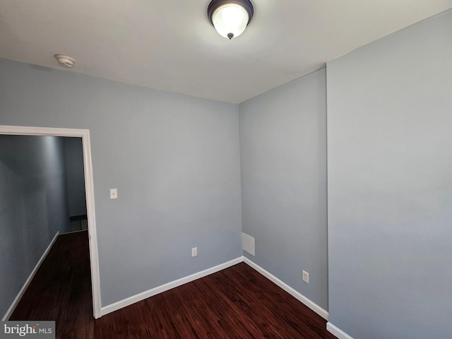 unfurnished room featuring dark wood-type flooring