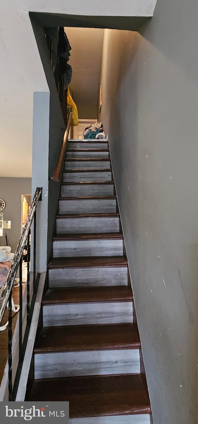 stairs featuring hardwood / wood-style flooring