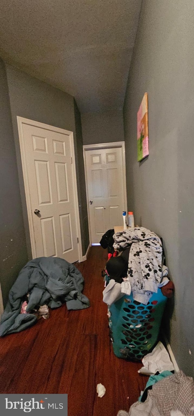 bedroom featuring wood-type flooring and a closet