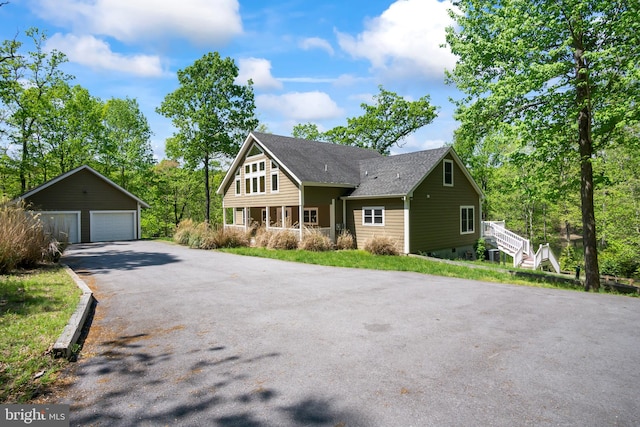 view of front of house featuring an outdoor structure and a garage