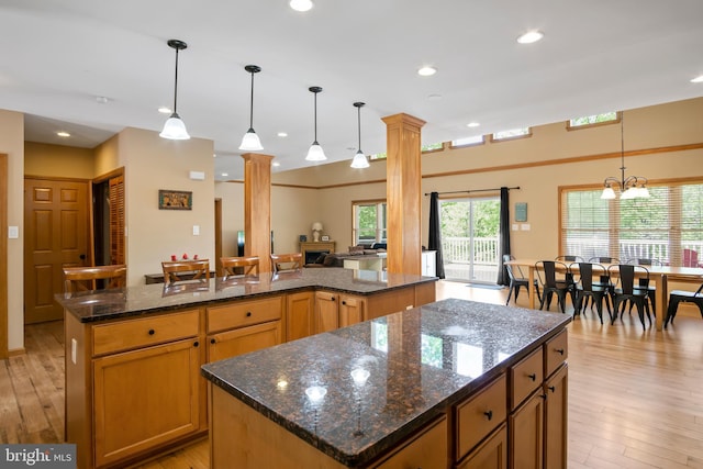 kitchen featuring a kitchen island, pendant lighting, and light hardwood / wood-style floors