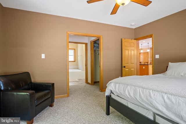 carpeted bedroom with connected bathroom, ceiling fan, and a closet