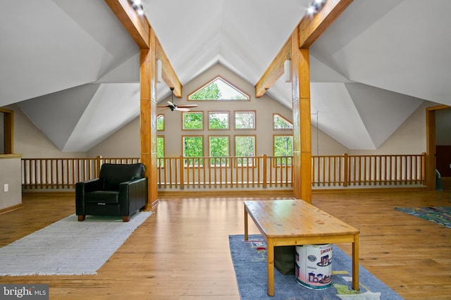 additional living space featuring lofted ceiling with beams, ceiling fan, and hardwood / wood-style flooring