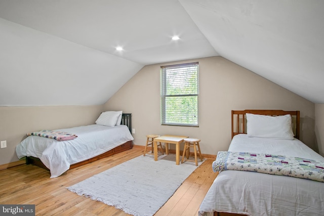 bedroom featuring vaulted ceiling and light hardwood / wood-style flooring