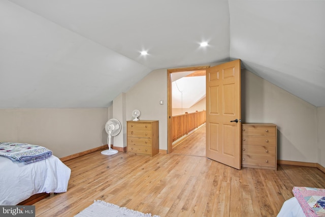 bedroom featuring lofted ceiling and light wood-type flooring