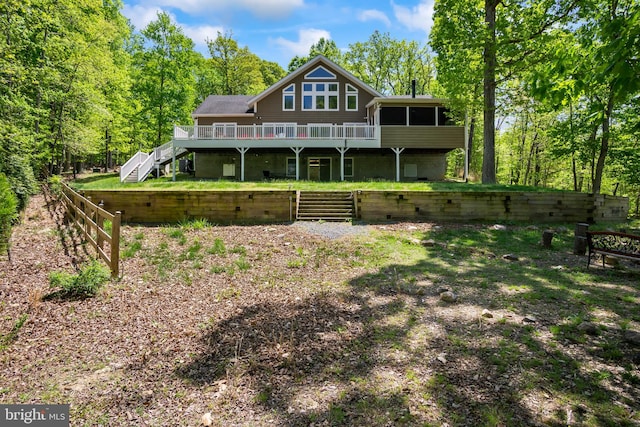 rear view of house featuring a deck