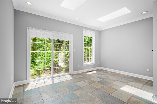 spare room featuring a skylight, crown molding, and tile flooring