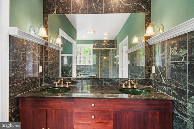 bathroom featuring tile walls, a shower with door, and dual vanity