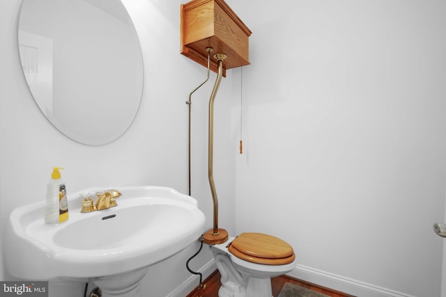 bathroom featuring sink, toilet, and hardwood / wood-style flooring