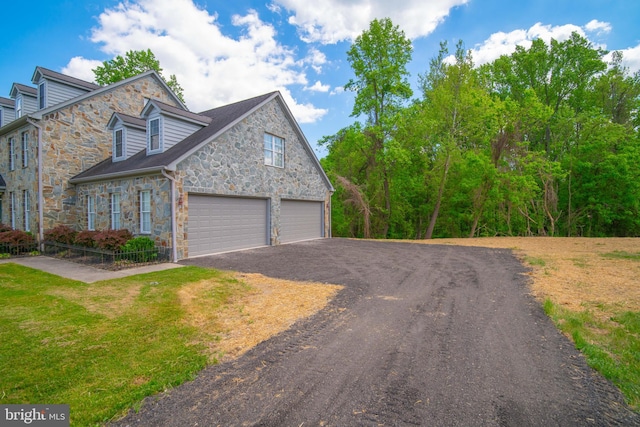 exterior space featuring a garage and a front lawn