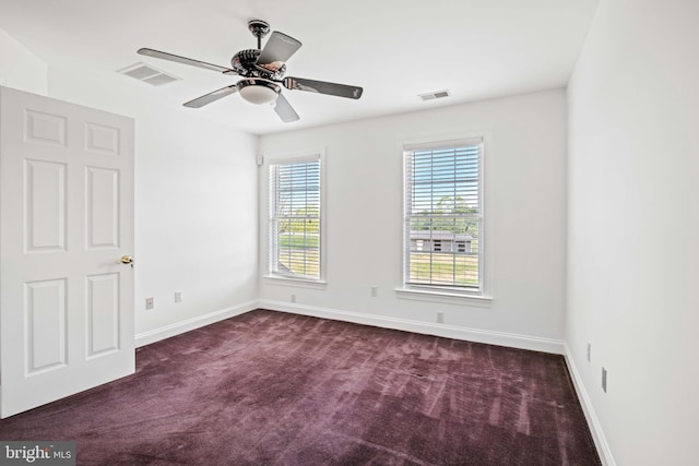 unfurnished room featuring ceiling fan and carpet flooring