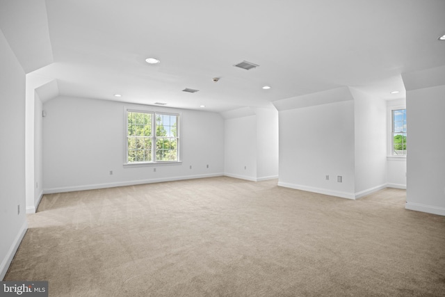 carpeted spare room featuring a healthy amount of sunlight