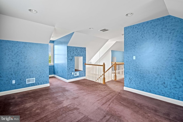 bonus room with lofted ceiling and carpet floors