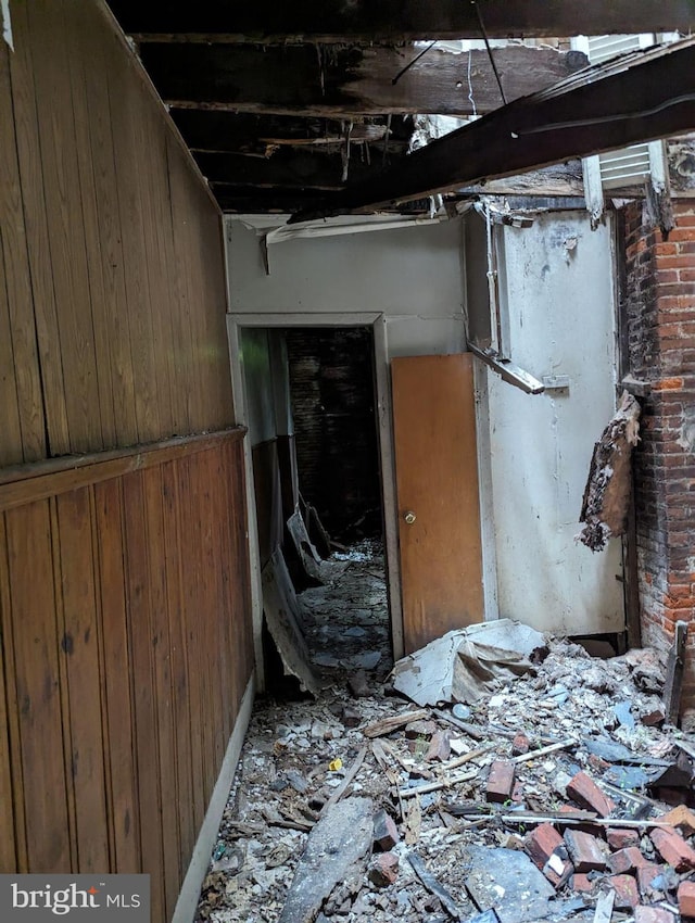 miscellaneous room featuring wooden walls