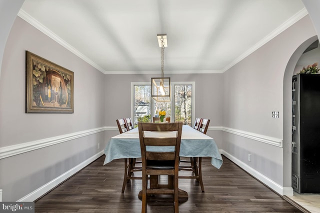 dining area with dark hardwood / wood-style flooring and crown molding