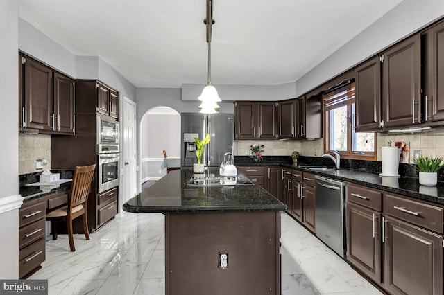 kitchen with pendant lighting, sink, dark brown cabinets, black appliances, and a kitchen island