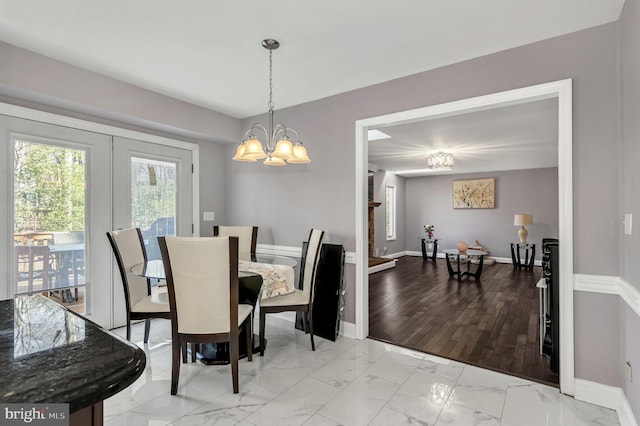 dining space with light wood-type flooring and a chandelier