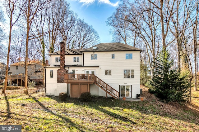 back of property featuring a lawn and a wooden deck