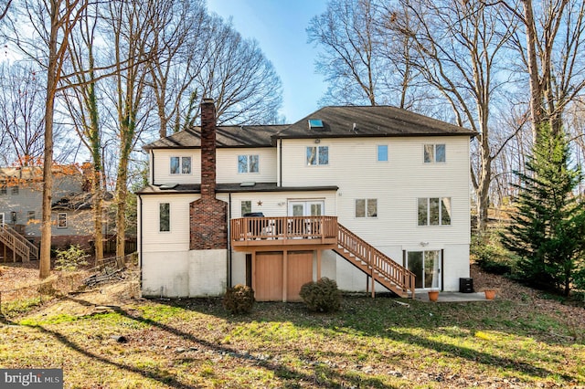 rear view of property with a wooden deck