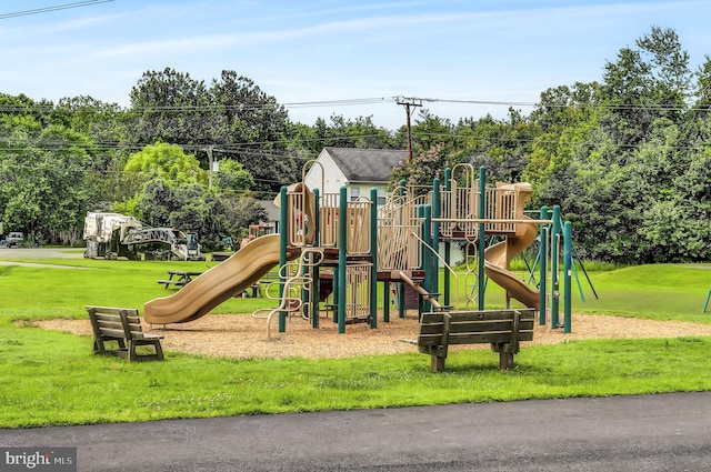 view of playground with a lawn