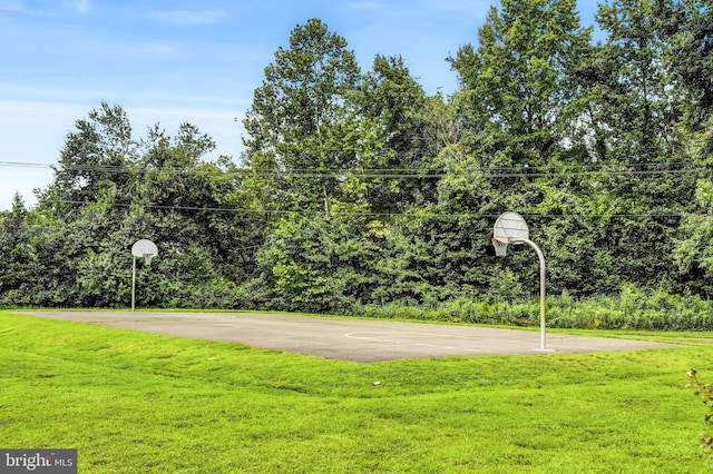 view of basketball court with a lawn