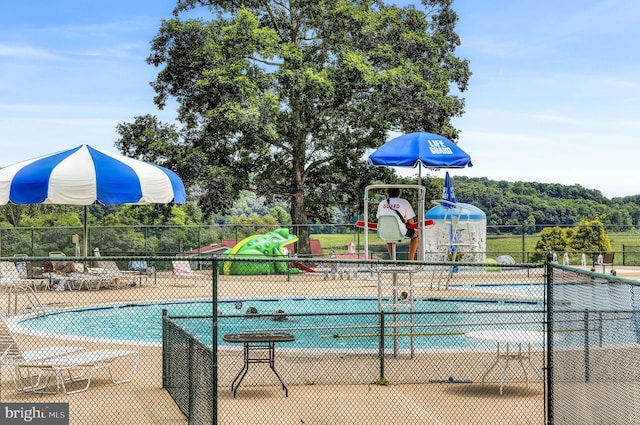 view of pool featuring a playground