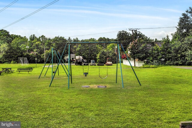 view of jungle gym featuring a lawn