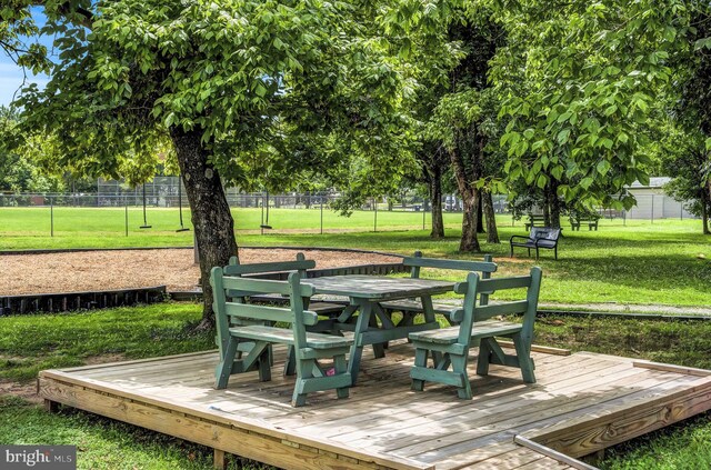 wooden deck featuring a lawn