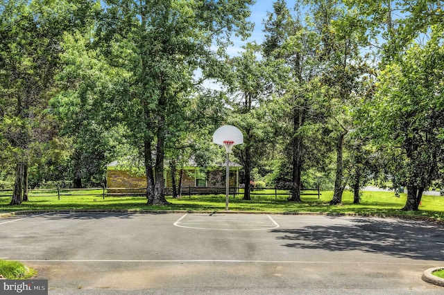 view of basketball court with a lawn