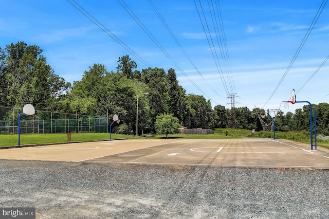 view of basketball court with a yard