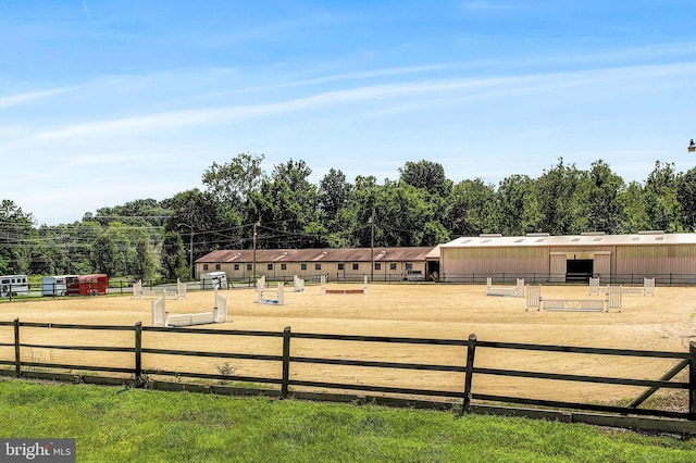 view of yard featuring an outdoor structure and a rural view