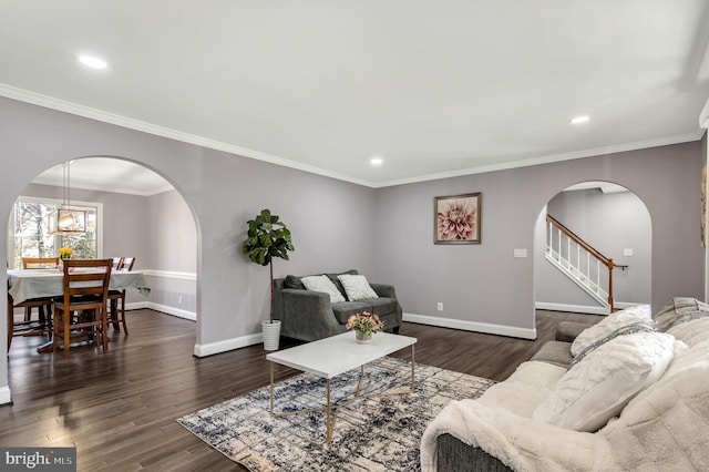 living room with dark hardwood / wood-style flooring and crown molding